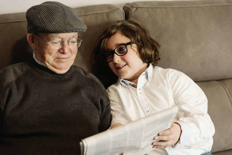 grandfather and grandson reading the news 1 1