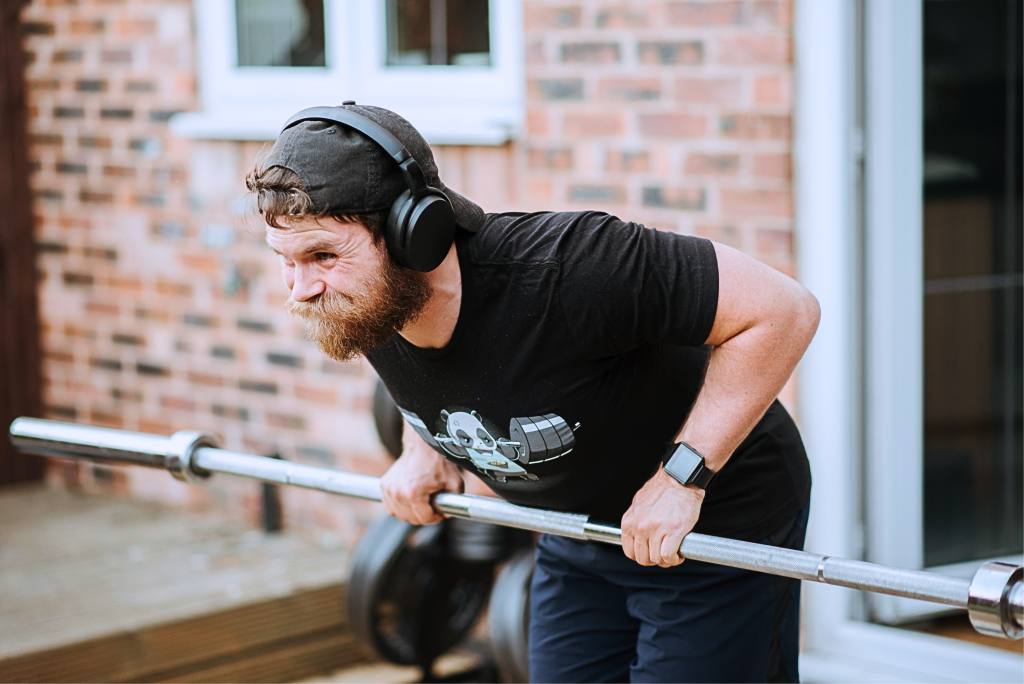 A man wearing Black over-ear headphones.
